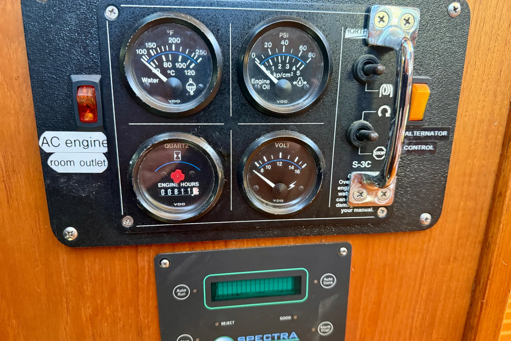 Control panel of a 1986 Nauticat 43 boat with gauges and switches.