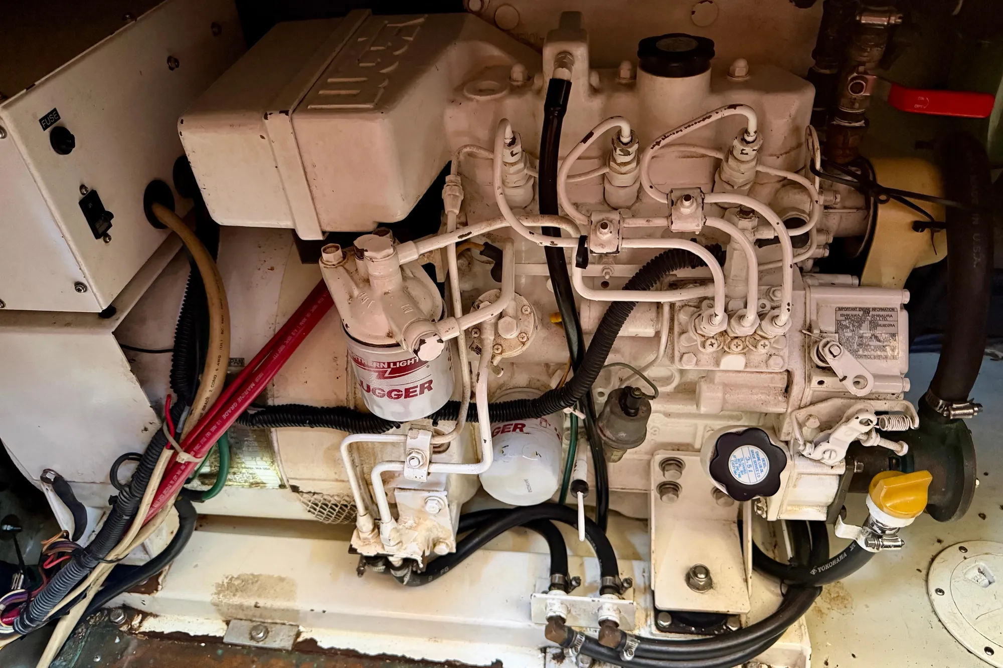 Engine compartment of a 1986 Nauticat 43 sailboat, showcasing detailed mechanical components.