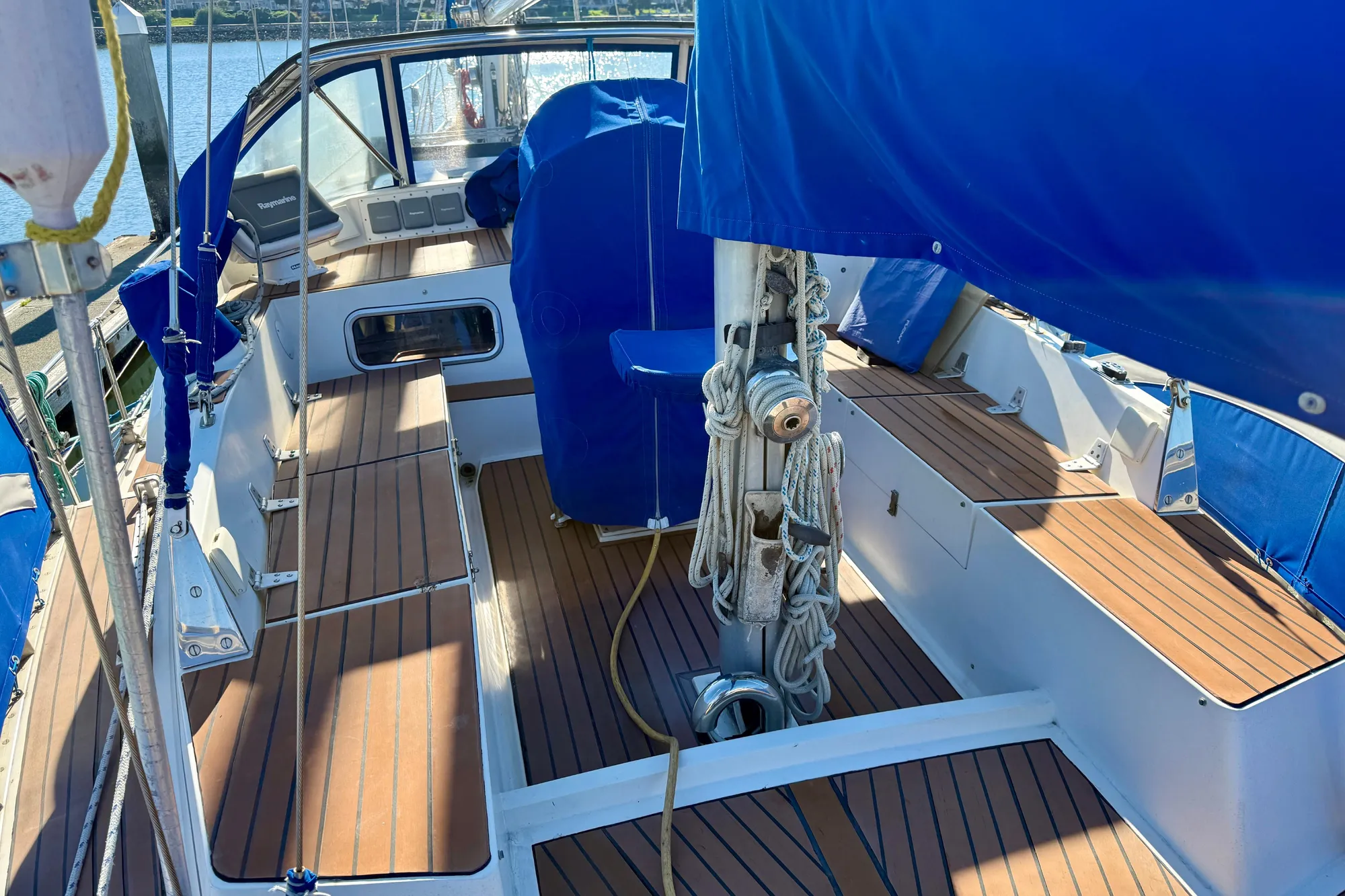 1986 Nauticat 43 sailboat cockpit with blue covers and FlexiTeak composite decking
