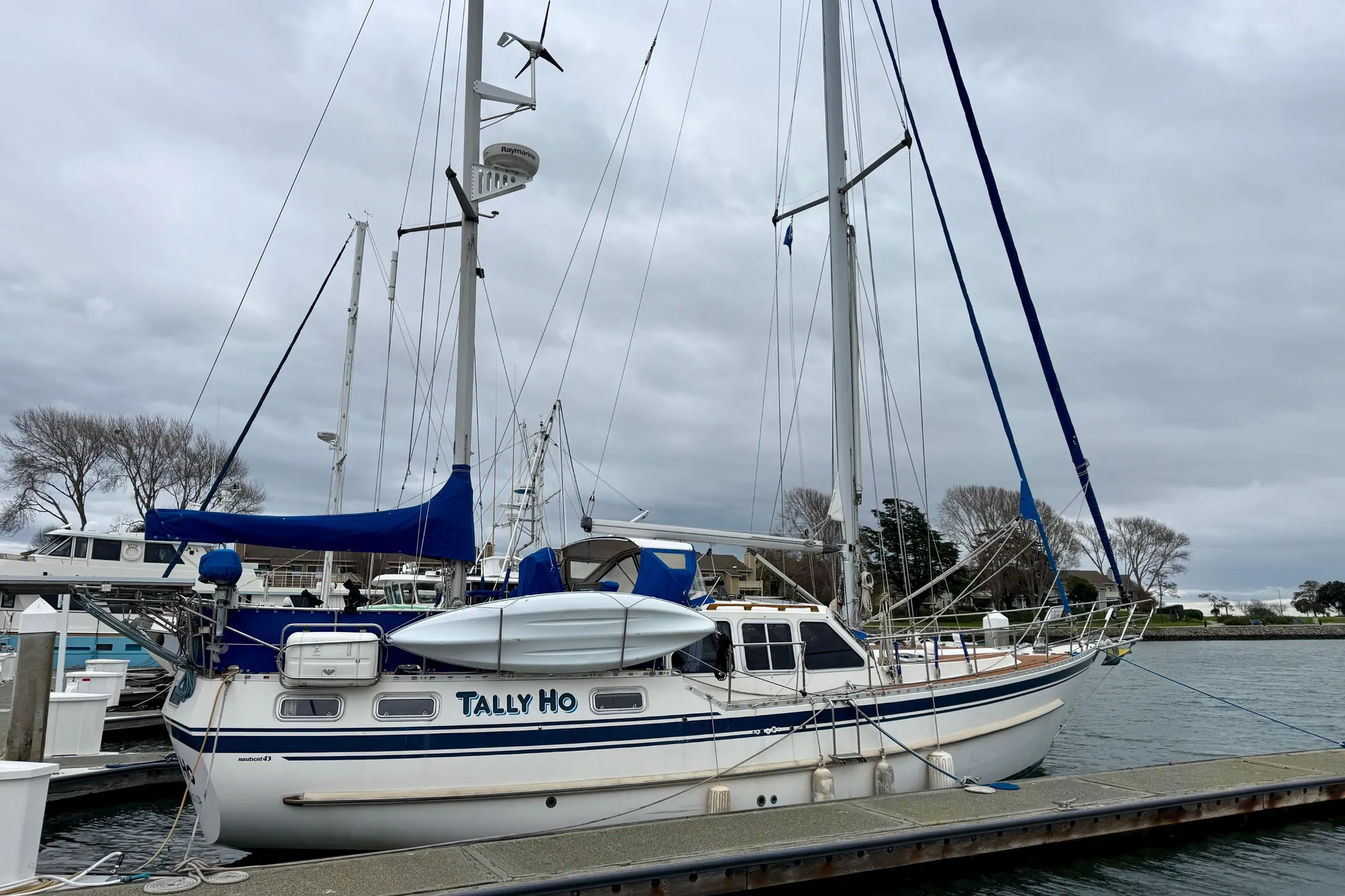 "TALLY HO," dockside with blue and white accents.