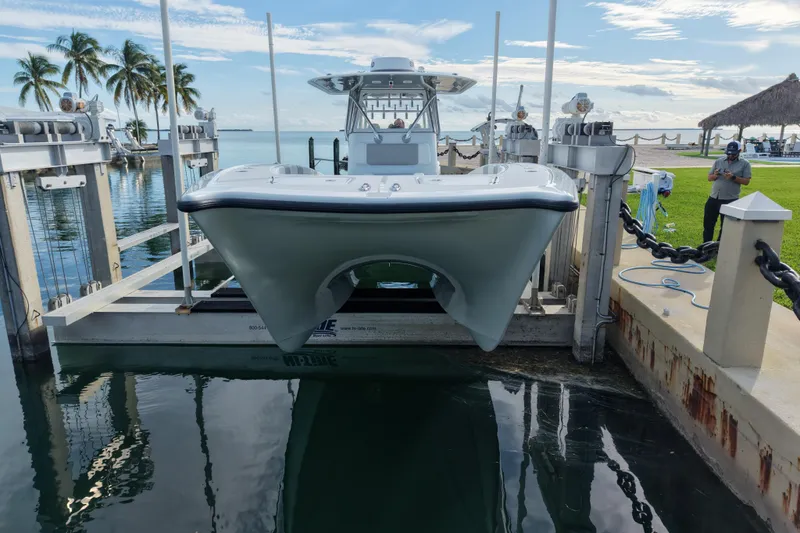  Yacht Photos Pics 2022 Freeman 34VH boat on lift by tropical waterfront with palm trees.