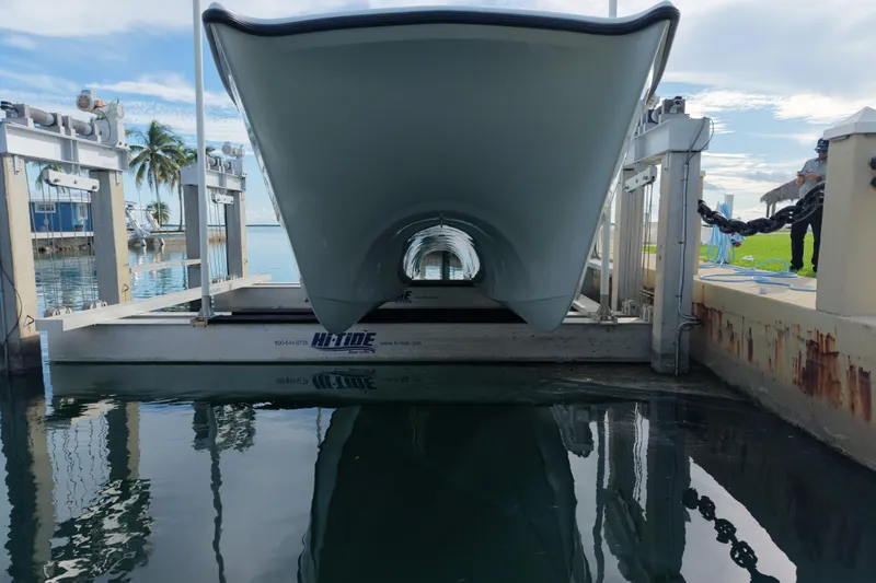  Yacht Photos Pics Freeman 34VH 2022 boat on lift, dockside with palm trees and clear sky.
