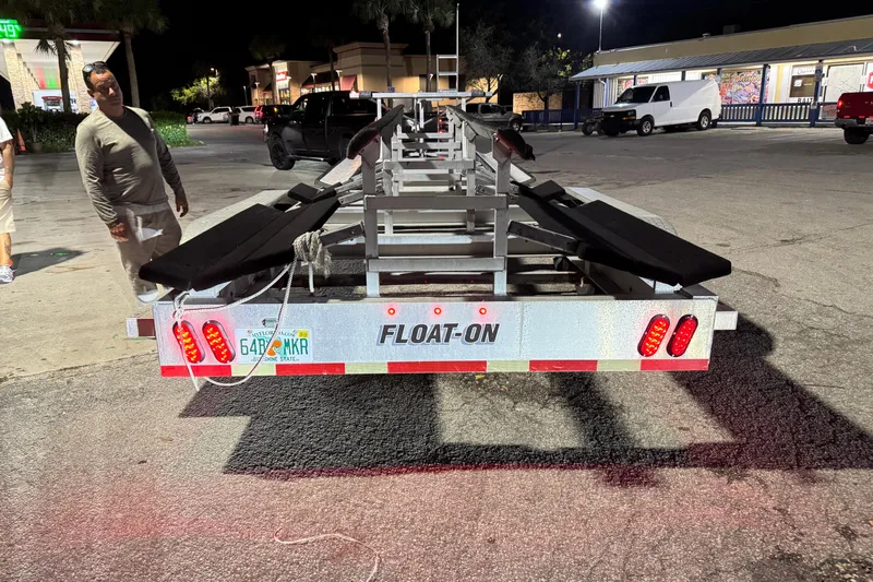  Yacht Photos Pics Freeman 34VH 2022 boat trailer at night, featuring Float-On design and Florida license plate.