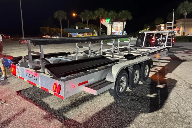  Yacht Photos Pics Trailer for Freeman 34VH 2022 model at night, featuring triple axles and "Float-On" branding.