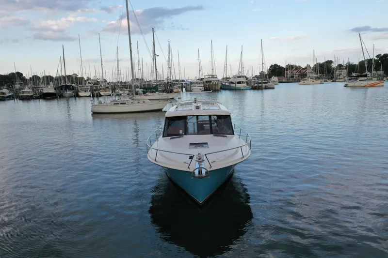 Promesa Yacht Photos Pics 2021 Hylas M44 yacht docked in a marina with sailboats in the background.