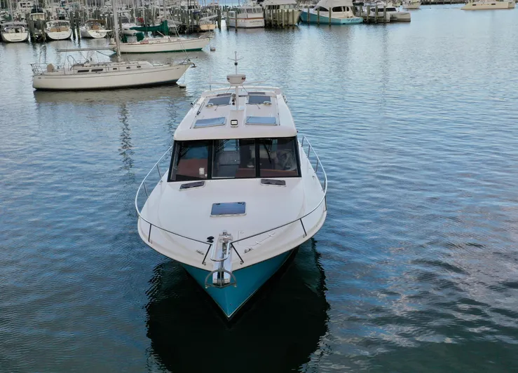 Promesa Yacht Photos Pics 2021 Hylas M44 yacht docked in a marina, surrounded by other boats.