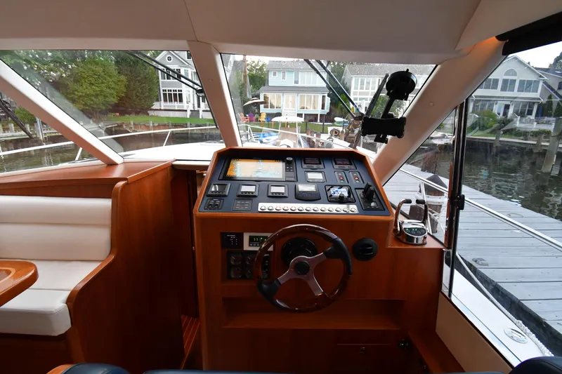 Promesa Yacht Photos Pics Helm of 2021 Hylas M44 yacht with modern controls and waterfront view.