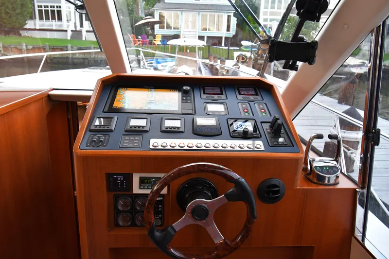 Promesa Yacht Photos Pics Helm of 2021 Hylas M44 yacht with navigation controls and wooden steering wheel.