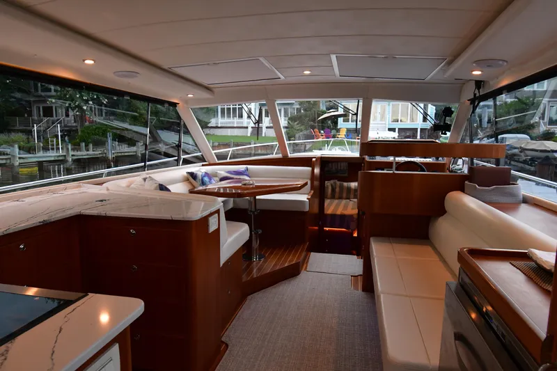 Promesa Yacht Photos Pics Luxurious interior of a 2021 Hylas M44 yacht with elegant seating and panoramic windows.