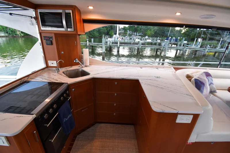 Promesa Yacht Photos Pics Luxurious kitchen interior of 2021 Hylas M44 yacht with modern appliances and waterfront view.