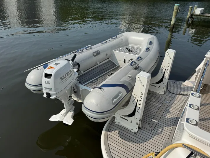Promesa Yacht Photos Pics Inflatable boat with Suzuki motor docked on water, Hylas M44, 2021 model.
