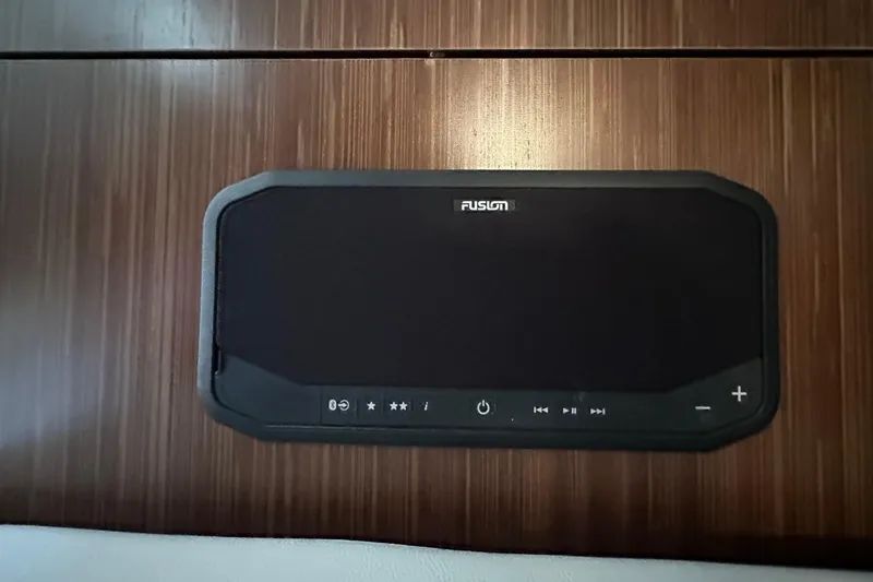 Jet Privé Yacht Photos Pics Fusion audio system on 2021 Sea Ray Sundancer 370 Outboard, mounted on wooden panel.
