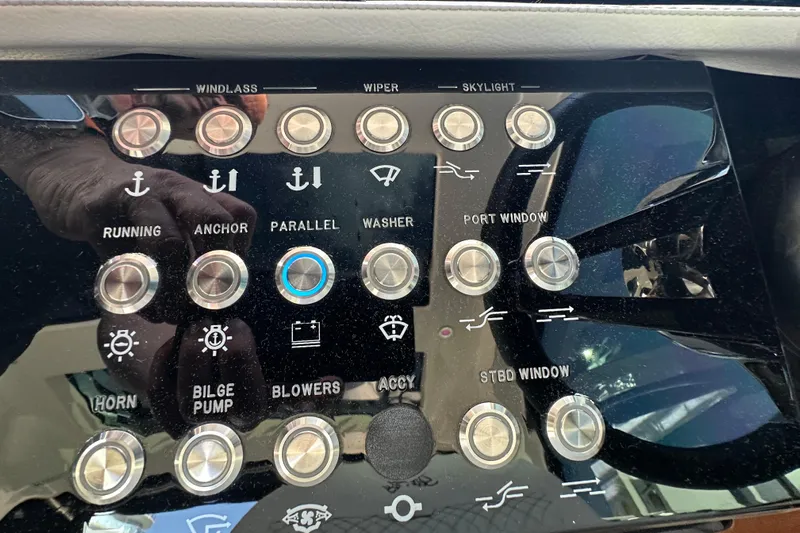 Jet Privé Yacht Photos Pics Control panel of a 2021 Sea Ray Sundancer 370 Outboard boat with various function buttons.