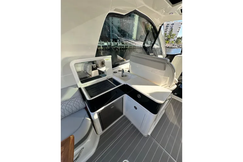 Jet Privé Yacht Photos Pics 2021 Searay 370ob boat interior with sleek kitchenette and modern design.