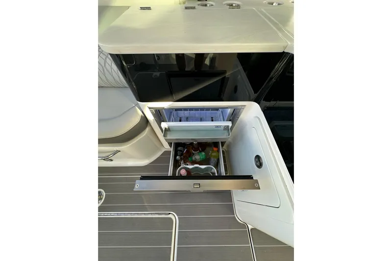 Jet Privé Yacht Photos Pics Open drawer refrigerator on 2021 Searay 370ob boat, stocked with beverages.