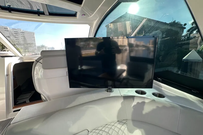 Jet Privé Yacht Photos Pics 2021 Searay 370ob yacht interior with TV and luxurious seating.