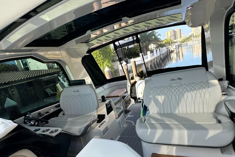 Jet Privé Yacht Photos Pics Interior of a 2021 Searay 370ob boat with luxurious seating and waterfront view.