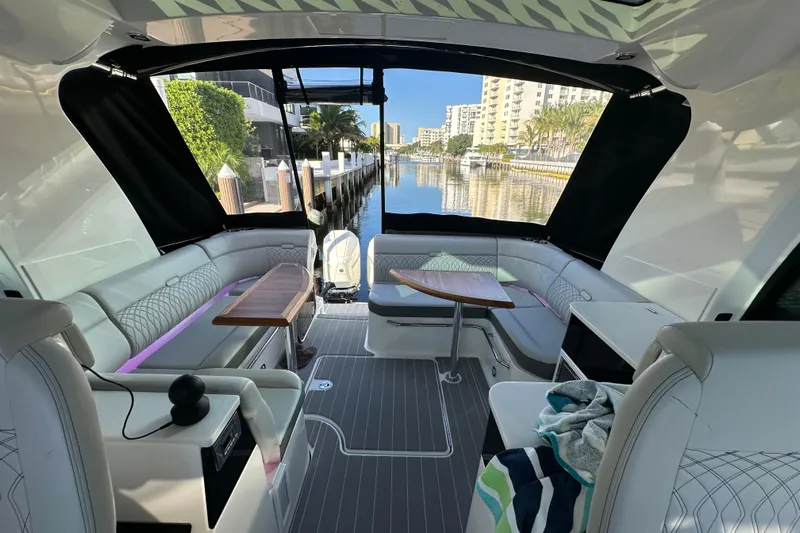 Jet Privé Yacht Photos Pics Interior of 2021 Searay 370ob boat with luxurious seating and waterfront view.