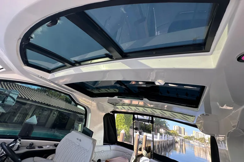 Jet Privé Yacht Photos Pics Interior view of 2021 Searay 370ob boat with panoramic sunroof and luxurious seating.