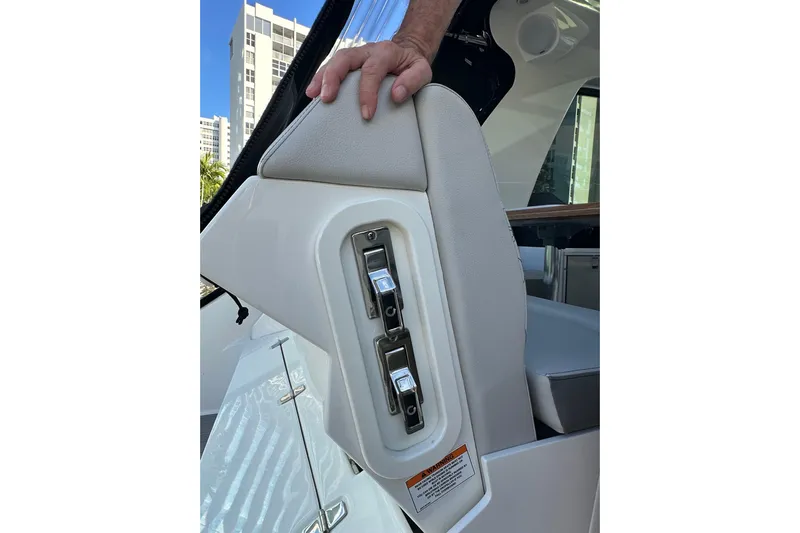 Jet Privé Yacht Photos Pics 2021 Searay 370ob boat interior with control panel and hand on seat.