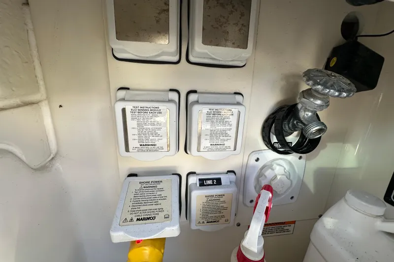 Jet Privé Yacht Photos Pics 2021 Searay 370ob boat electrical panel with shore power and water connections.