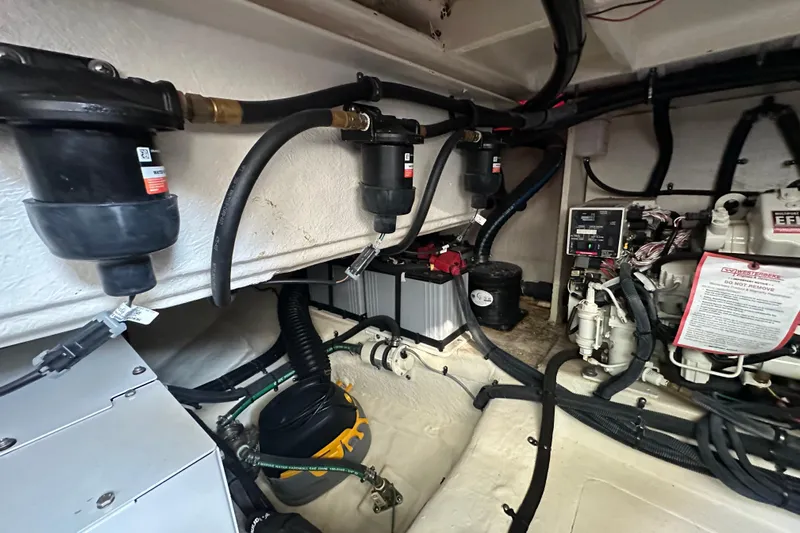 Jet Privé Yacht Photos Pics Engine room of 2021 Searay 370ob boat with mechanical components and wiring.