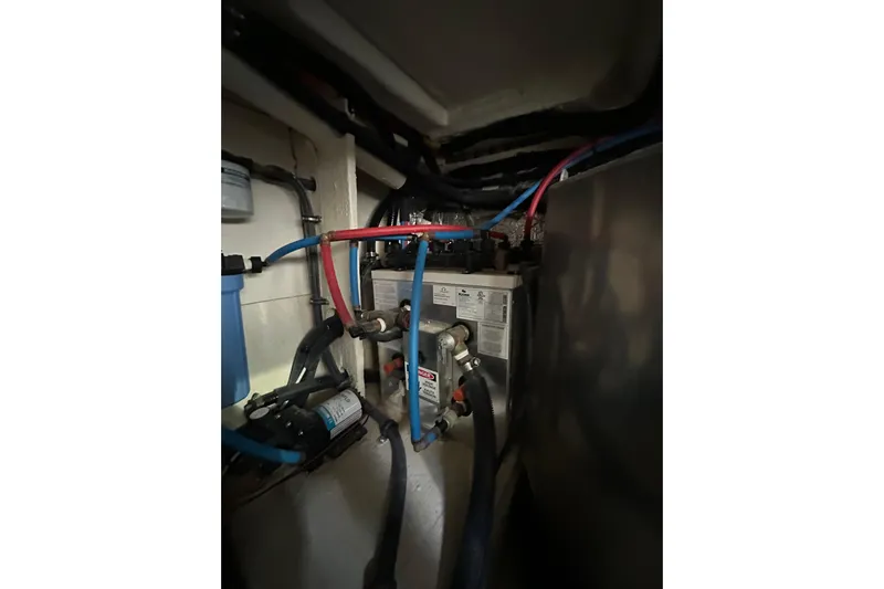 Jet Privé Yacht Photos Pics Engine compartment of 2021 Searay 370ob boat with visible wiring and components.