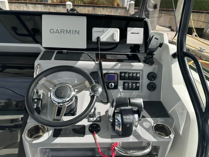 Jebang Yacht Photos Pics 2023 Jeanneau Leader 9.0 CC helm with Garmin navigation and control panel.