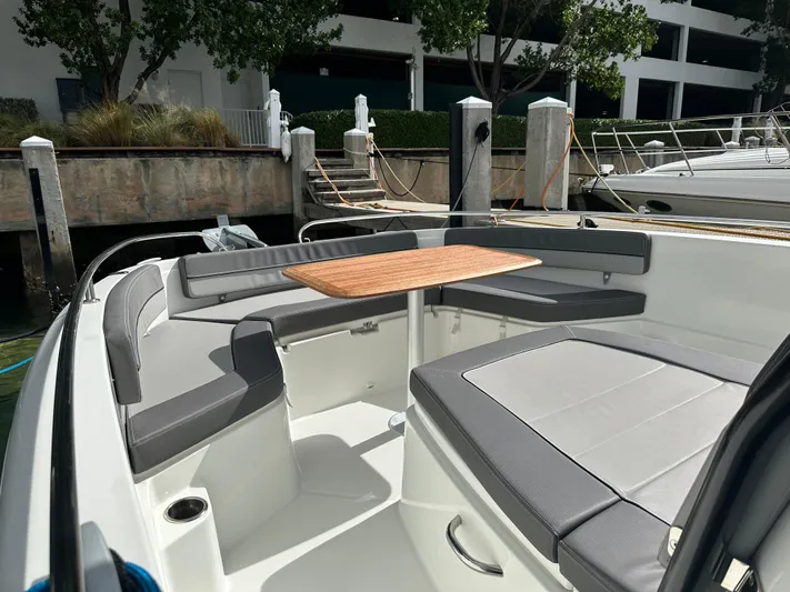 Jebang Yacht Photos Pics 2023 Jeanneau Leader 9.0 CC boat with spacious seating and wooden table.
