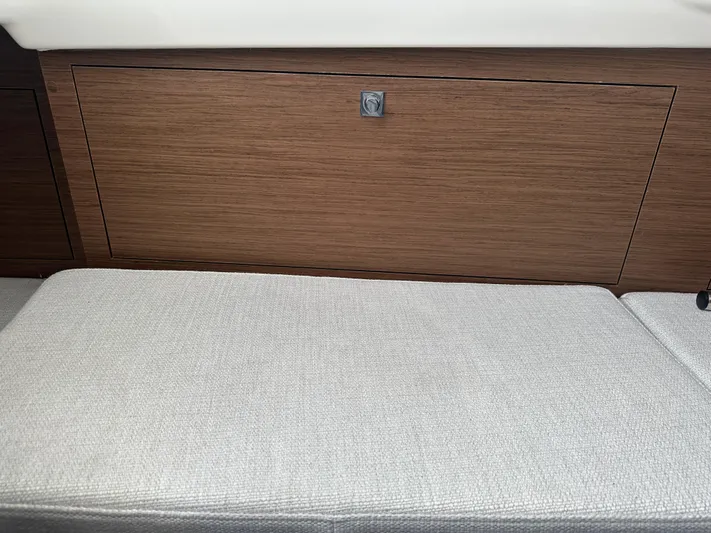 Jebang Yacht Photos Pics 2023 Jeanneau Leader 9.0 CC interior with wood paneling and cushioned seating.