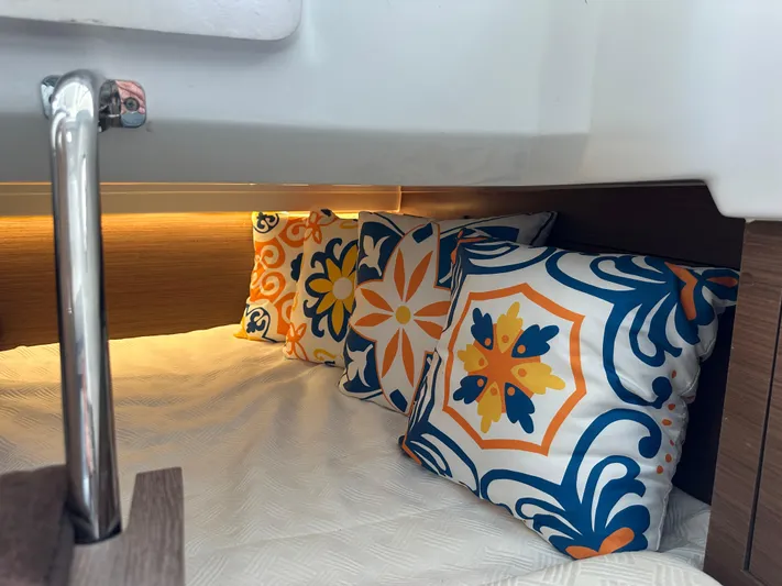 Jebang Yacht Photos Pics Cozy cabin interior of 2023 Jeanneau Leader 9.0 CC with colorful decorative pillows.