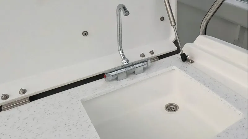 Jebang Yacht Photos Pics 2023 Jeanneau Leader 9.0 CC boat sink with modern faucet and speckled countertop.