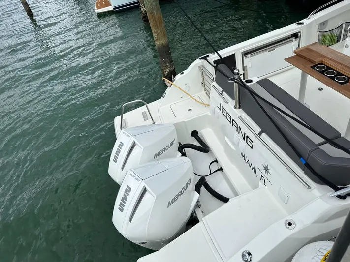 Jebang Yacht Photos Pics 2023 Jeanneau Leader 9.0 CC boat with twin Mercury outboard engines docked in water.