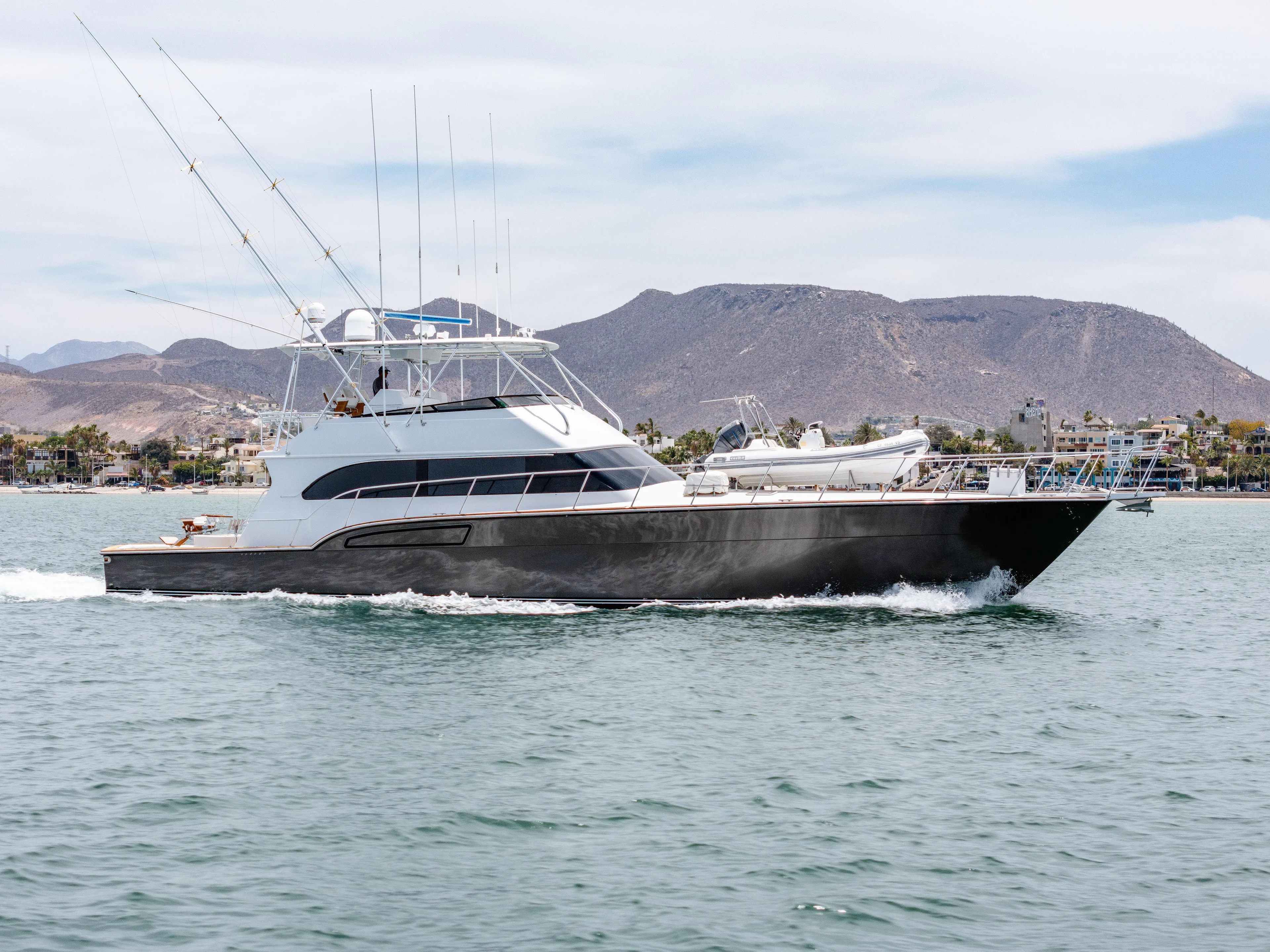 Tiger Spirit Yacht Photos Pics 1995 Donzi 72 Convertible yacht cruising on a scenic lake with mountainous backdrop.
