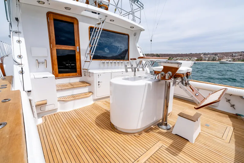 Tiger Spirit Yacht Photos Pics 1995 Donzi 72 Convertible yacht deck with wooden flooring and fishing equipment.