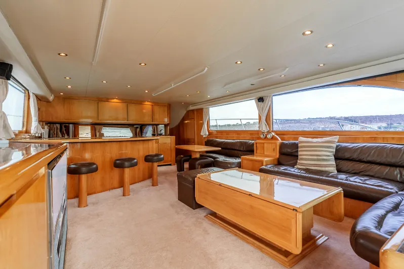 Tiger Spirit Yacht Photos Pics Luxurious interior of a 1995 Donzi 72 Convertible yacht with leather seating and wooden finishes.