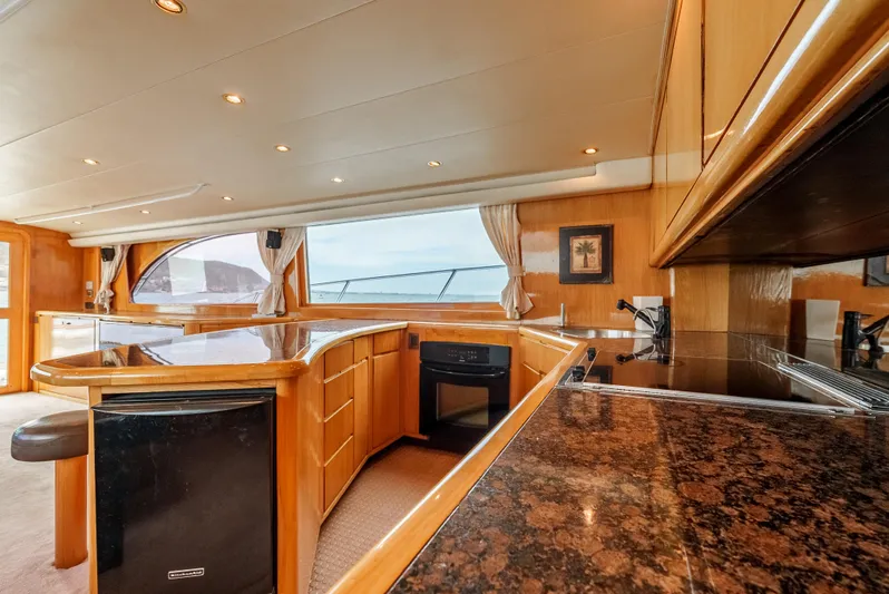 Tiger Spirit Yacht Photos Pics Luxurious interior of a 1995 Donzi 72 Convertible yacht with elegant wood finishes.