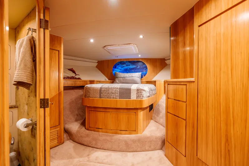 Tiger Spirit Yacht Photos Pics Luxurious cabin interior of 1995 Donzi 72 Convertible yacht with wood finish and cozy bed.