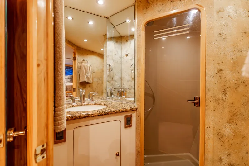 Tiger Spirit Yacht Photos Pics Luxurious bathroom interior of 1995 Donzi 72 Convertible yacht with granite countertop and glass shower.