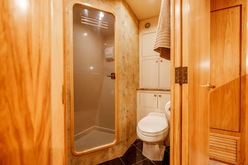 Tiger Spirit Yacht Photos Pics Luxurious bathroom in 1995 Donzi 72 Convertible yacht with shower and wooden accents.