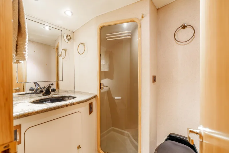 Tiger Spirit Yacht Photos Pics Luxurious bathroom in 1995 Donzi 72 Convertible yacht with modern fixtures and elegant design.