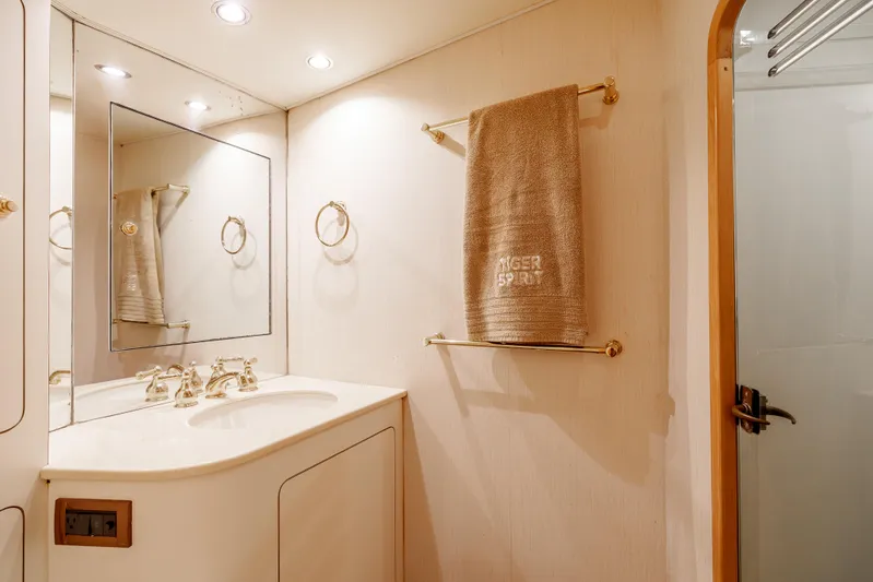 Tiger Spirit Yacht Photos Pics Luxurious bathroom in a 1995 Donzi 72 Convertible yacht, featuring elegant fixtures and lighting.
