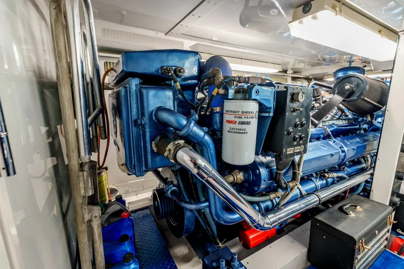 Tiger Spirit Yacht Photos Pics Engine room of a 1995 Donzi 72 Convertible yacht, showcasing a powerful blue engine.