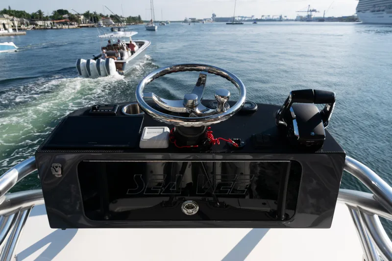  Yacht Photos Pics 2020 SeaVee 390Z boat helm with steering wheel and controls on open water.