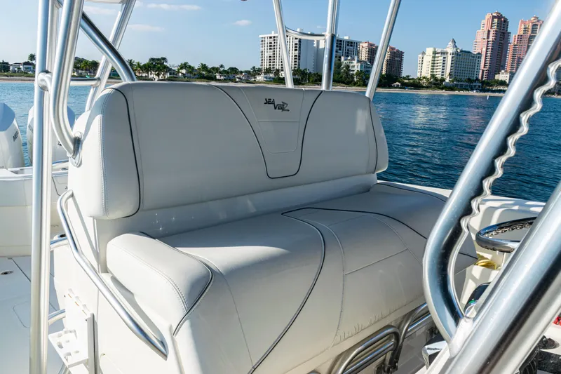 Yacht Photos Pics 2020 SeaVee 390Z boat interior with white seating, ocean and cityscape background.