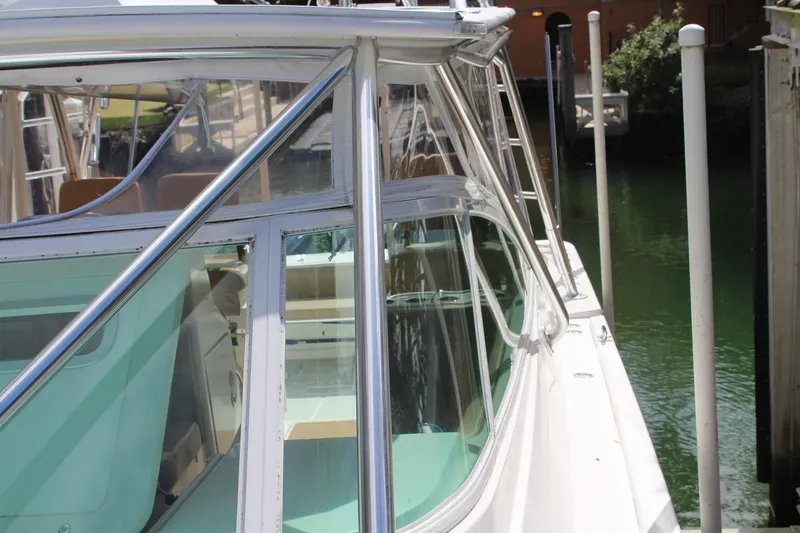 Maripal Yacht Photos Pics 2008 Contender 38 Express boat docked, side view with clear windows and sleek design.