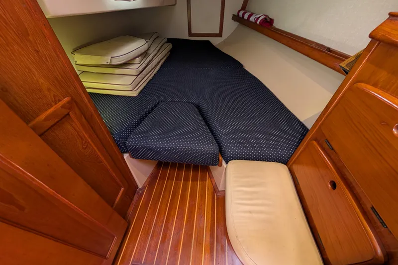 Lone Star Yacht Photos Pics 1988 Island Packet 38 cabin interior with wooden finish and cushioned sleeping area.