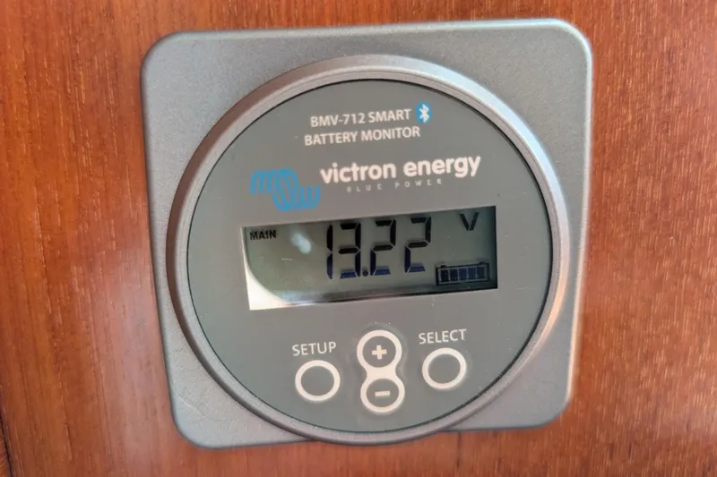 Lone Star Yacht Photos Pics Victron Energy BMV-712 battery monitor displaying 13.22 volts on Island Packet 38, 1988 model.