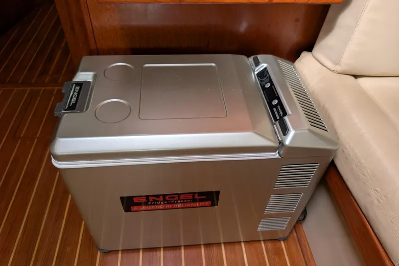 Lone Star Yacht Photos Pics Engel fridge-freezer on 1988 Island Packet 38 yacht, wooden floor, beige seating.