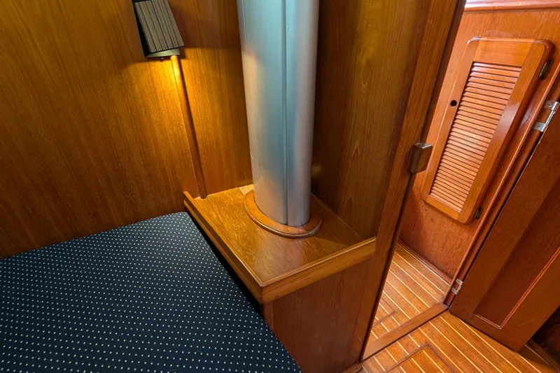 Lone Star Yacht Photos Pics Interior of 1988 Island Packet 38 sailboat with wood paneling and cozy lighting.